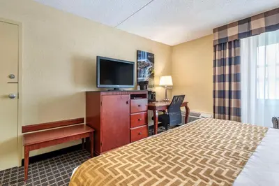 a hotel room with a bed and a flat screen tv at Best Western Plus Bridgeport Inn in Bridgeport