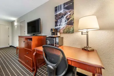 a room with a desk with a computer and a television at Best Western Plus Bridgeport Inn in Bridgeport
