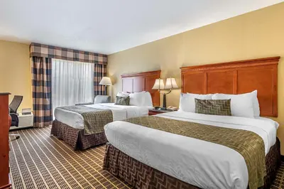 a hotel room with two beds and a window at Best Western Plus Bridgeport Inn in Bridgeport