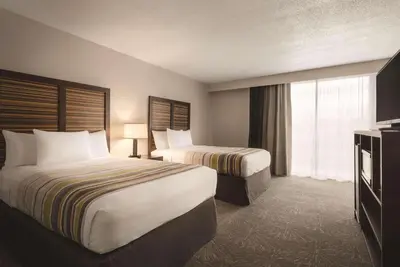 a hotel room with two beds and a television at Country Inn & Suites by Radisson, Erlanger - Cincinnati South in Erlanger