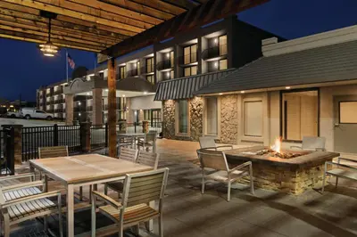a patio with a table and chairs and a fire pit at Country Inn & Suites by Radisson, Erlanger - Cincinnati South in Erlanger