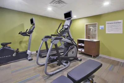 a gym with two exercise bikes in a room at Holiday Inn Express Tiffin by IHG in Tiffin