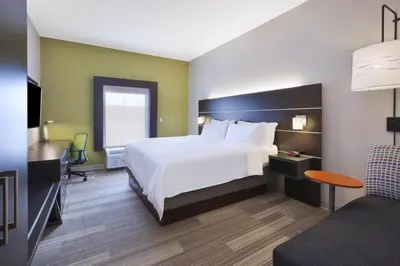 a hotel room with a bed and a desk at Holiday Inn Express Tiffin by IHG in Tiffin