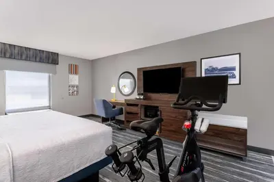 a hotel room with a bed and a bike in a room at Hampton Inn & Suites Richmond in Richmond