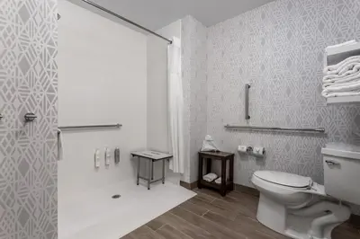 a white bathroom with a toilet and a shower at Hampton Inn & Suites Richmond in Richmond