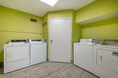 a laundry room with two machines and a door at Clarion Hotel Conference Center Lexington North in Lexington