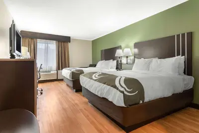 a hotel room with two beds and a flat screen tv at Quality Inn Fairborn near Wright Patterson AFB in Fairborn