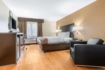 a hotel room with a bed and a couch at Quality Inn Fairborn near Wright Patterson AFB in Fairborn