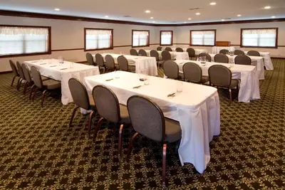 a conference room with white tables and chairs at Carlisle Inn Walnut Creek in Walnut Creek