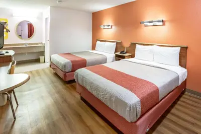 a hotel room with two beds and a television at Motel 6-Dayton, OH - Englewood in Englewood