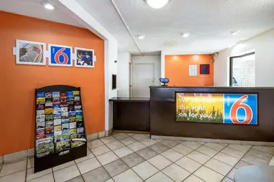 a waiting room with an orange wall and a sign at Motel 6-Dayton, OH - Englewood in Englewood