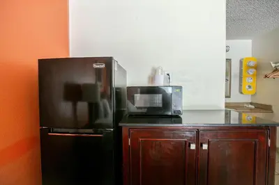 a kitchen with a black refrigerator and a microwave at Motel 6-Dayton, OH - Englewood in Englewood