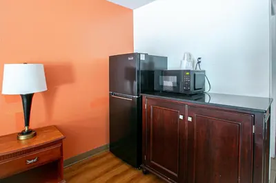 a kitchen with a black refrigerator and a microwave at Motel 6-Dayton, OH - Englewood in Englewood