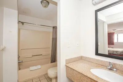 a bathroom with a sink and a toilet and a mirror at Motel 6-Dayton, OH - Englewood in Englewood