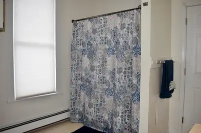 a shower curtain in a room with a window at Cozy 2nd story Flat near downtown in Adrian