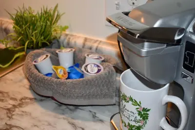 a coffee maker sitting on top of a counter with a cup at Cozy 2nd story Flat near downtown in Adrian