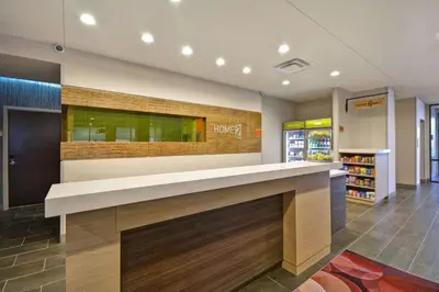 a lobby with a reception counter in a store at Home2 Suites By Hilton Columbus Airport East Broad in Columbus
