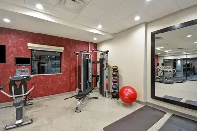 a gym with cardio equipment and a large mirror at Home2 Suites By Hilton Columbus Airport East Broad in Columbus