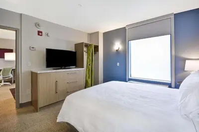 a bedroom with a bed and a flat screen tv at Home2 Suites By Hilton Columbus Airport East Broad in Columbus