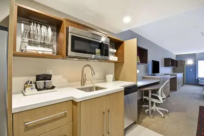 a kitchen with a sink and a microwave at Home2 Suites By Hilton Columbus Airport East Broad in Columbus
