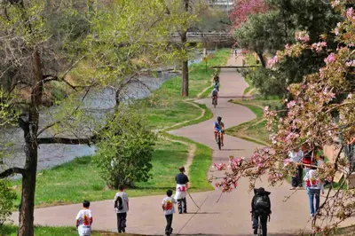 a group of people riding bikes down a path in a park at Holiday Inn Toledo - Maumee I-80/90 by IHG in Maumee