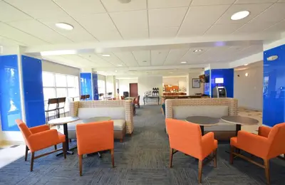 a waiting room with tables and chairs in an office at Holiday Inn Express Toledo-Oregon by IHG in Oregon