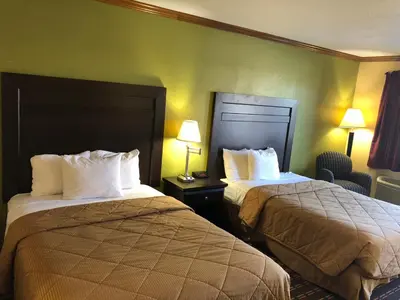 a hotel room with two beds and two lamps at Americas Best Value Inn Maumee/Toledo in Maumee