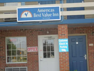 a building with a best value line sign and a door at Americas Best Value Inn Maumee/Toledo in Maumee