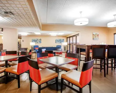 a dining room with tables and chairs at Comfort Inn Dayton - Huber Heights in Huber Heights