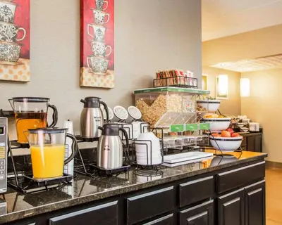 a kitchen with a counter with orange juice and food at Comfort Inn Dayton - Huber Heights in Huber Heights