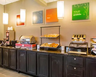 a buffet line with bread and pastries on it at Comfort Inn Dayton - Huber Heights in Huber Heights