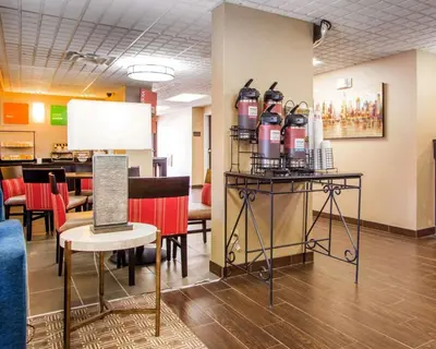 a waiting room with chairs and a table with wine bottles at Comfort Inn Dayton - Huber Heights in Huber Heights