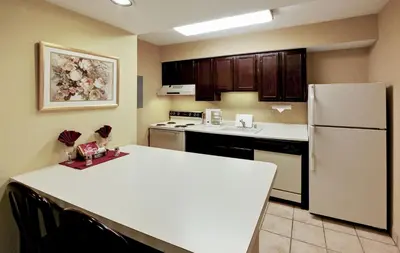 a kitchen with a white refrigerator and a counter top at Hawthorn Extended Stay by Wyndham Dayton in Dayton
