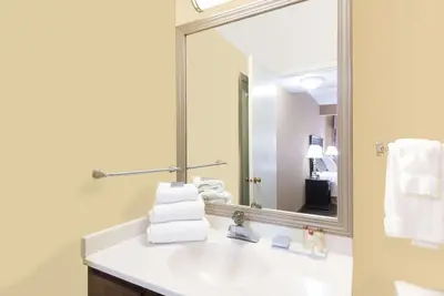 a bathroom with a sink and a mirror at Hawthorn Extended Stay by Wyndham Dayton in Dayton