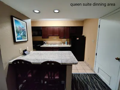 a kitchen with a black refrigerator and a counter at Hawthorn Extended Stay by Wyndham Dayton in Dayton