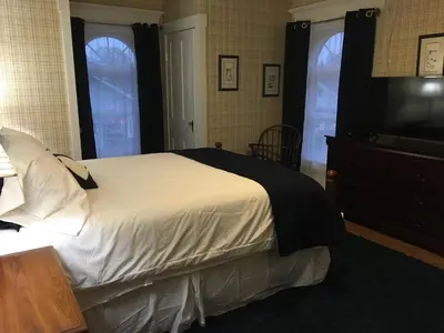 a bedroom with a large bed and a television at The Doctor's Inn in Oxford
