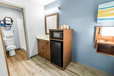 a small bathroom with a sink and a microwave at HomeTowne Studios by Red Roof Florence, KY-Cincinnati Airport in Florence