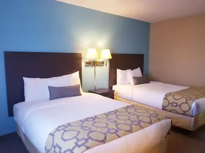 a hotel room with two beds and two lamps at Baymont Inn & Suites by Wyndham Huber Heights Dayton Northeast in Huber Heights