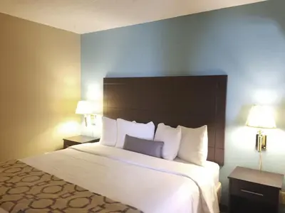 a large bed in a hotel room with two lamps at Baymont Inn & Suites by Wyndham Huber Heights Dayton Northeast in Huber Heights