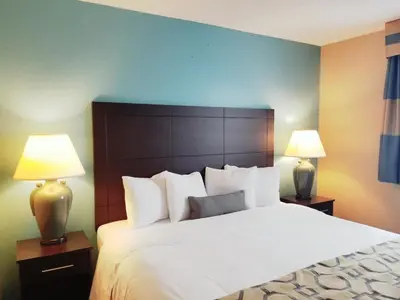 a bedroom with a large white bed with two lamps at Baymont Inn & Suites by Wyndham Huber Heights Dayton Northeast in Huber Heights
