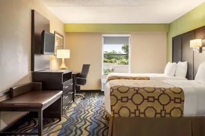 a hotel room with two beds and a desk at Baymont by Wyndham Georgetown Lexington North in Georgetown