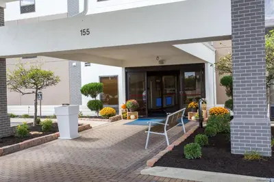 a porch with a chair in front of a building at Holiday Inn Express Wilmington by IHG in Wilmington