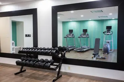 a mirror in a gym with rows of dumbbells at Holiday Inn Express Wilmington by IHG in Wilmington