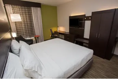 a hotel room with a bed and a desk at Holiday Inn Express Wilmington by IHG in Wilmington