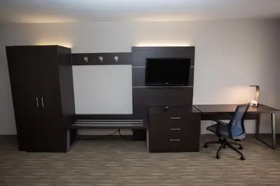 an office with a desk and a tv and a chair at Holiday Inn Express Wilmington by IHG in Wilmington