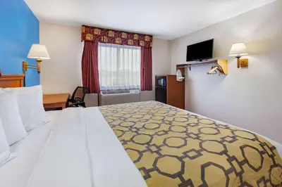 a hotel room with a large bed and a window at Baymont by Wyndham Perrysburg-Toledo in Perrysburg