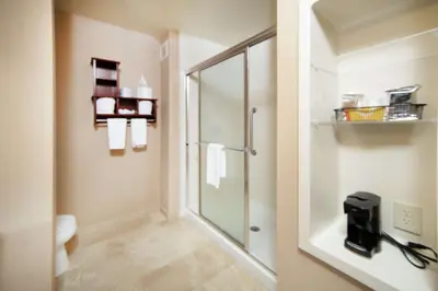 a bathroom with a shower and a glass shower stall at Hampton Inn & Suites Greensburg in Greensburg