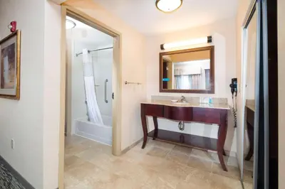 a bathroom with a sink and a mirror at Hampton Inn & Suites Greensburg in Greensburg