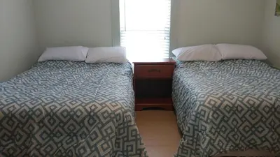 two beds sitting next to each other in a bedroom at Aunt Jane's Guest House in Put-in-Bay