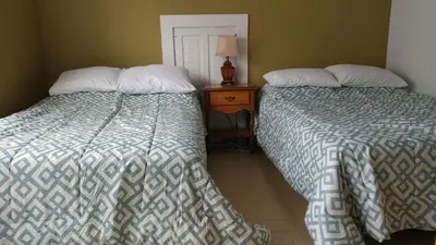 two beds sitting next to each other in a bedroom at Aunt Jane's Guest House in Put-in-Bay